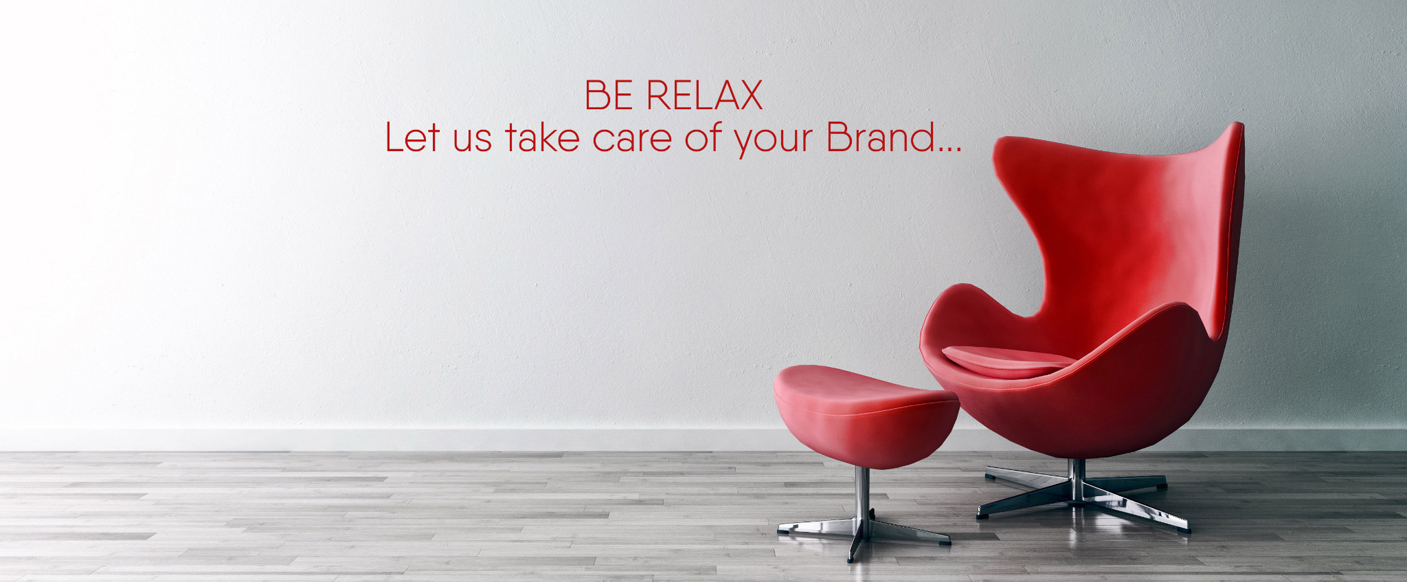 A sculptural red lounge chair with the message: Be relax. Let us take care of your brand.